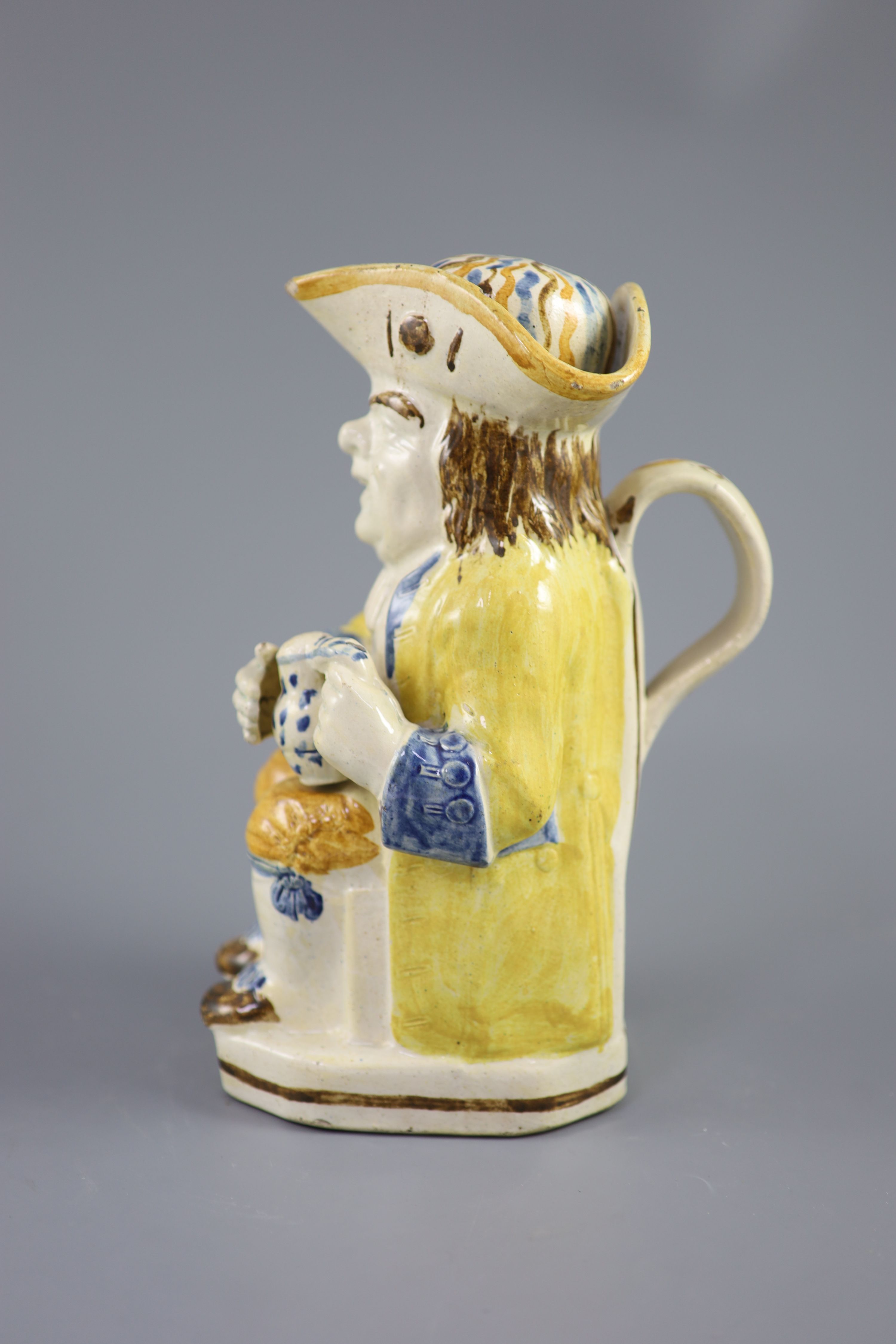 A Staffordshire Prattware Good Hearty Fellow Toby jug with rare hat measure, c.1790-1800, 25cm high